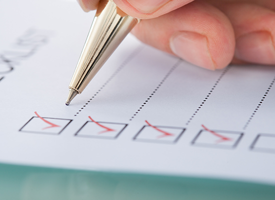 Businessman preparing checklist at office desk